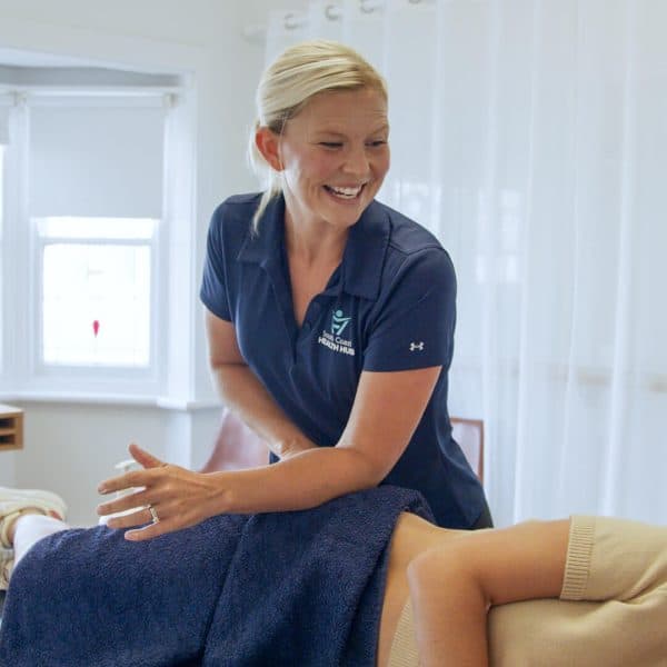 South Coast Health Hub clinician assessing a patient's knee in a treatment room