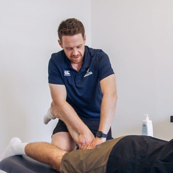 South Coast Health Hub physiotherapist treating a patient's leg on a treatment table